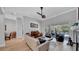 Open living room features modern furnishings, hardwood floors and access to the pool area at 15507 Avocetview Ct, Lithia, FL 33547