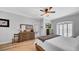 Relaxing main bedroom with wood floors, shutters, and a flat screen television at 15507 Avocetview Ct, Lithia, FL 33547