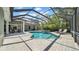 Beautiful in-ground screened pool with a brick patio and ample space for relaxing at 15507 Avocetview Ct, Lithia, FL 33547