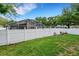 Fenced backyard with flowers and a screened in patio at 16905 Hawkridge Rd, Lithia, FL 33547