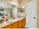 Well-lit bathroom with granite countertops, soaking tub, and shower at 16905 Hawkridge Rd, Lithia, FL 33547