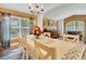 Bright dining room with hardwood floors, chandelier, and access to a living area at 16905 Hawkridge Rd, Lithia, FL 33547