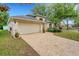 Charming single-story home with a brick driveway, two-car garage, and well-maintained landscaping at 16905 Hawkridge Rd, Lithia, FL 33547