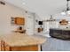 Open kitchen features granite island, bar seating, and view into the adjacent living area at 16905 Hawkridge Rd, Lithia, FL 33547