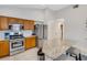 Modern kitchen featuring granite countertops, stainless steel appliances, and a breakfast bar at 16905 Hawkridge Rd, Lithia, FL 33547