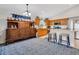 Open kitchen with granite island, modern appliances, and hardwood cabinets at 16905 Hawkridge Rd, Lithia, FL 33547