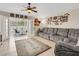 Bright living room with a view to the backyard and an oversized couch at 16905 Hawkridge Rd, Lithia, FL 33547