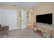 Relax in this secondary living room with TV, side table and closet for storage at 16905 Hawkridge Rd, Lithia, FL 33547