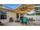 Patio seating area with an umbrella for shade and outdoor dining at 16905 Hawkridge Rd, Lithia, FL 33547