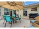 Covered patio features a table with chairs and an outdoor grill at 16905 Hawkridge Rd, Lithia, FL 33547