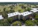An aerial view shows the building next to a beautiful golf course and mature trees at 1817 Golfview Dr # 1817, Tarpon Springs, FL 34689