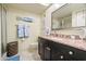 Bathroom with granite vanity, stylish mirror, and beach themed decor at 1817 Golfview Dr # 1817, Tarpon Springs, FL 34689