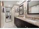 Bathroom featuring double sinks, granite countertops, and a mirrored closet at 1817 Golfview Dr # 1817, Tarpon Springs, FL 34689