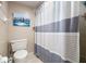 Clean bathroom featuring a shower with a striped curtain and a standard toilet at 1817 Golfview Dr # 1817, Tarpon Springs, FL 34689