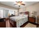 Comfortable bedroom with rich hardwood floors, a ceiling fan and a large window at 1817 Golfview Dr # 1817, Tarpon Springs, FL 34689