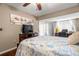 An inviting bedroom with a ceiling fan and a workspace with lots of light at 1817 Golfview Dr # 1817, Tarpon Springs, FL 34689