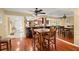 Dining area open to kitchen with hardwood floors, mirrored wall, and seating for four at 1817 Golfview Dr # 1817, Tarpon Springs, FL 34689