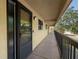 Hallway view with neutral decor and a view of a mature tree canopy at 1817 Golfview Dr # 1817, Tarpon Springs, FL 34689