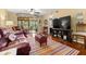 Inviting living room with leather furniture, colorful rug, and sliding glass doors to balcony at 1817 Golfview Dr # 1817, Tarpon Springs, FL 34689