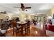 Open-concept living and dining area with wood floors, mirrored wall, and ceiling fans at 1817 Golfview Dr # 1817, Tarpon Springs, FL 34689