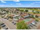 Aerial view of community featuring townhomes, tennis courts, a pool, and lush landscaping in a scenic area at 1930 Laughing Gull Ln # 1225, Clearwater, FL 33762