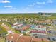 Aerial view of residential community featuring townhomes, pool, tennis courts, and parking at 1930 Laughing Gull Ln # 1225, Clearwater, FL 33762