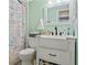 Stylish bathroom with a modern vanity, seashell theme decor and a shower featuring a new curtain at 1930 Laughing Gull Ln # 1225, Clearwater, FL 33762