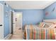 Blue bedroom featuring a queen bed with a beach theme, closet and views to living space at 1930 Laughing Gull Ln # 1225, Clearwater, FL 33762