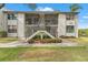 A two-story exterior unit showcases the charming entrance, staircase, and beautiful greenery around the property at 1930 Laughing Gull Ln # 1225, Clearwater, FL 33762