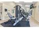 Well-equipped gym featuring modern weight machines, a wall mirror, and mounted tv at 1930 Laughing Gull Ln # 1225, Clearwater, FL 33762