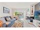 A cozy living room features a fireplace, comfortable seating, and views to the screened in patio at 1930 Laughing Gull Ln # 1225, Clearwater, FL 33762