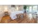 Bright primary bedroom with hardwood floors, a comfortable bed, and natural light at 216 Pine Ave # R, Anna Maria, FL 34216