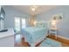 Comfortable bedroom with a queen bed, blue accents, and patio access at 216 Pine Ave # R, Anna Maria, FL 34216
