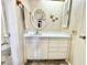 Bathroom with an oval mirror, decorative butterflies and a white sink at 225 Country Club Dr # A207, Largo, FL 33771