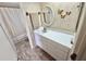 Bathroom with a shower/tub combination, decorative butterflies and a white sink at 225 Country Club Dr # A207, Largo, FL 33771