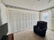 Bedroom featuring large wardrobe and a cozy recliner at 225 Country Club Dr # A207, Largo, FL 33771