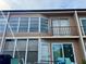 Exterior view of building with multiple windows, a balcony, and outdoor seating area at 225 Country Club Dr # A207, Largo, FL 33771