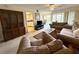 Bright living room with a ceiling fan, a large cabinet, and views of the kitchen and dining area at 225 Country Club Dr # A207, Largo, FL 33771
