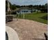 Relaxing outdoor patio with tiled flooring and tranquil views of pond at 225 Country Club Dr # A207, Largo, FL 33771