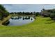 Picturesque pond with palm tree reflections, nestled among manicured lawns and lush greenery, for a tranquil atmosphere at 225 Country Club Dr # A207, Largo, FL 33771