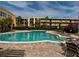 This community pool features a well-manicured deck with lounge chairs and is surrounded by lush tropical landscaping at 225 Country Club Dr # A207, Largo, FL 33771