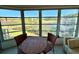 Enclosed sunroom with beautiful view of the pond and outdoor scenery at 225 Country Club Dr # A207, Largo, FL 33771