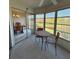 Enclosed sunroom with view of the pond and outdoor scenery next to the dining area at 225 Country Club Dr # A207, Largo, FL 33771