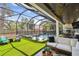A screened-in patio includes a full seating arrangement, grilling area, and an inviting backyard pool at 2402 W Parkland Blvd, Tampa, FL 33609