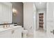 Stylish bathroom featuring a modern vanity, decorative wallpaper, and a uniquely designed door leading to the shower at 2402 W Parkland Blvd, Tampa, FL 33609