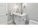Clean bathroom featuring a white vanity with ample storage, a large mirror, and modern sconce lighting at 2402 W Parkland Blvd, Tampa, FL 33609