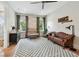 Cozy bedroom with a comfortable sofa, crib, and a large patterned rug at 2402 W Parkland Blvd, Tampa, FL 33609