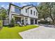 Elegant two-story home with a manicured lawn, covered porch, and a paved driveway at 2402 W Parkland Blvd, Tampa, FL 33609