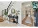 Bright foyer with staircase, stylish table, and an open view into the home's hallway at 2402 W Parkland Blvd, Tampa, FL 33609