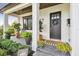 Charming front porch featuring stylish decor, lush plants, and a welcoming entrance at 2402 W Parkland Blvd, Tampa, FL 33609